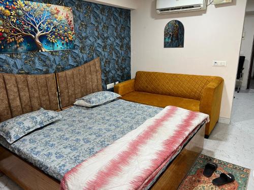 a bedroom with a bed and a couch at Zirakpur 3 Peoples Sleeping in Zirakpur