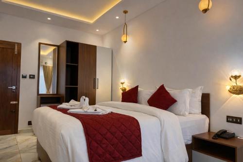 a hotel room with two beds and a mirror at Hotel Materhorn in Kovalam
