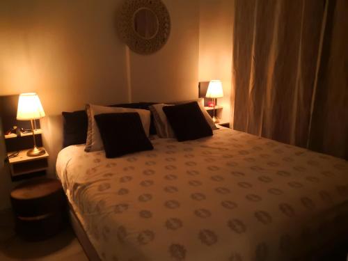 a bedroom with a large bed with two lamps at Marvest 1 in Hua Hin