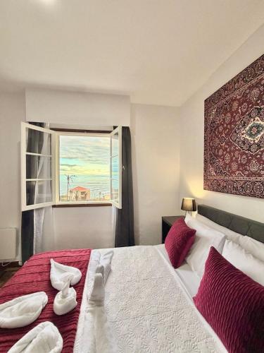 a bedroom with a large bed with a window at Ocean View Guest House in São Vicente