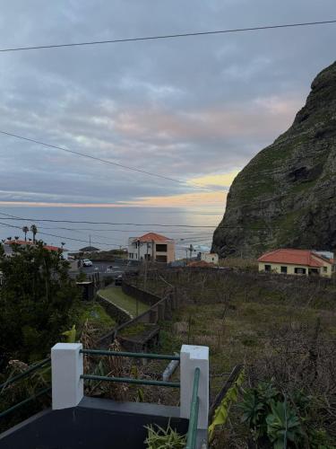a view of a hill with a house and the ocean at Ocean View Guest House in São Vicente