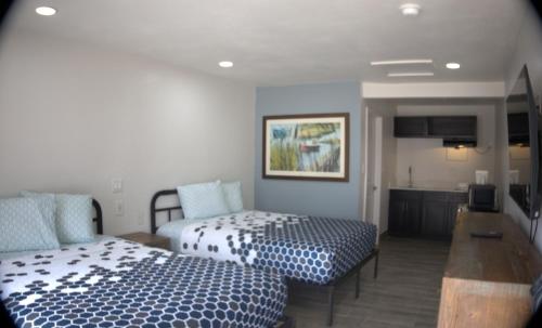 a hotel room with two beds and a kitchen at Rodeway Inn in Livingston