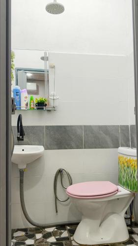 a bathroom with a pink toilet and a sink at KAMI roomstay 2 in Kampong Banggol Lalang