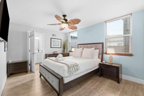 a bedroom with a bed and a ceiling fan at Stunning Beach Home - large patio, parking, ac & dog friendly! in San Diego