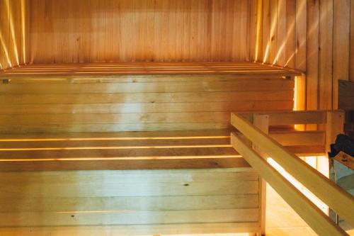 
a wooden staircase leading up to a room with a bench at Hotel Sokol in Sorochinsk
