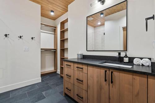 a bathroom with a sink and a mirror at The Dacha in Island Park