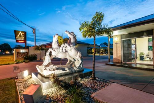 a statue of four horses in front of a building at Athena Studio Units in Roma