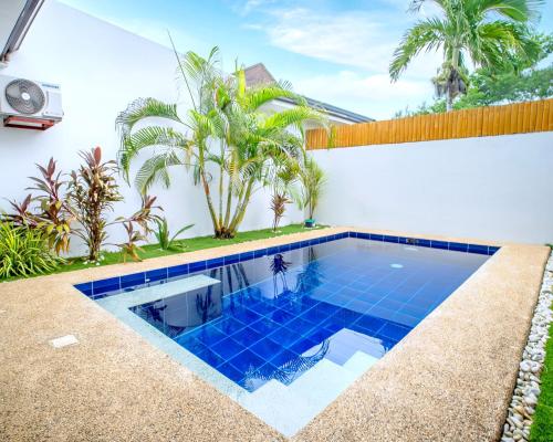 a swimming pool in the backyard of a house at Bali Villas Panglao Bohol in Panglao Island