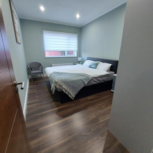a bedroom with a bed and a window at Sea View Apartment in Cobh
