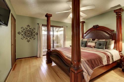 a bedroom with a large bed with a wooden post at Alpine Getaway 62 in Helen