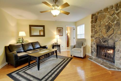 a living room with a couch and a fireplace at Bavarian Brook Condo 15 in Helen