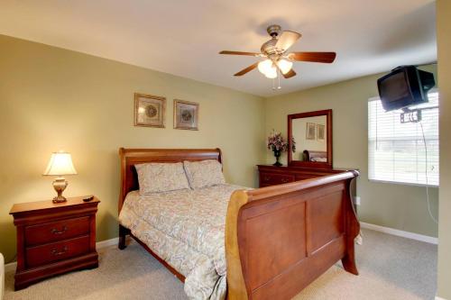 a bedroom with a bed and a ceiling fan at Bavarian Brook Condo 15 in Helen