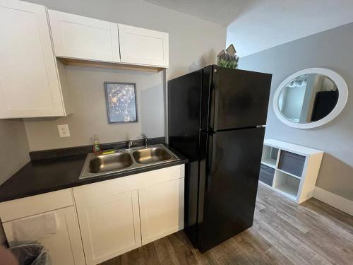 a kitchen with a black refrigerator and a sink at Bavarian Brook Unit 6 in Helen