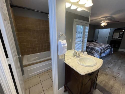 a bathroom with a sink and a bed and a mirror at Bavarian Brook Unit 9 in Helen