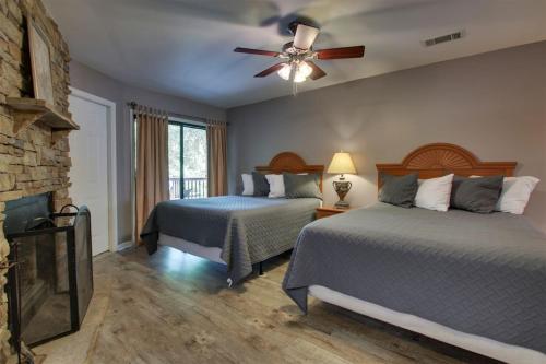 a bedroom with two beds and a fireplace at Rivers Edge 703 in Helen