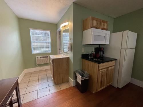a kitchen with a sink and a white refrigerator at Bavarian Brook Unit 7 in Helen