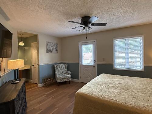 a bedroom with a bed and a ceiling fan at Rivers Edge 802 in Helen