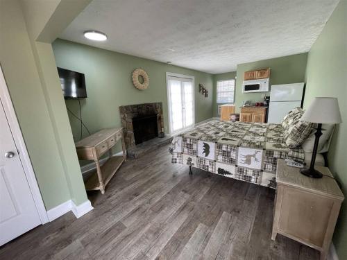 a bedroom with a bed and a fireplace at Bavarian Brook Unit 9a in Helen