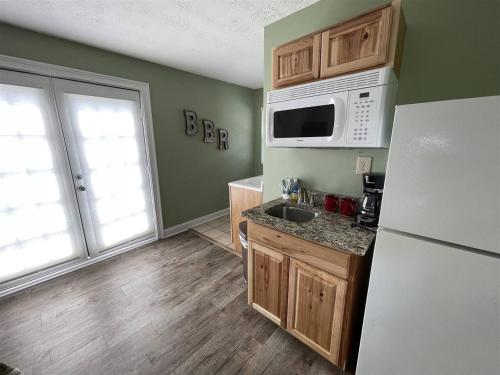 a kitchen with a white refrigerator and a sink at Bavarian Brook Unit 9a in Helen