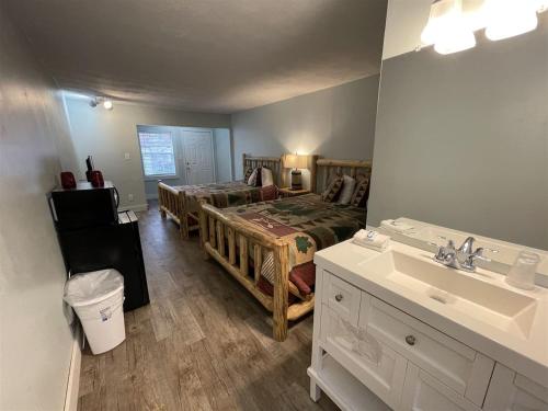 a bathroom with a bed and a sink in a room at Bavarian Brook Unit 6A in Helen