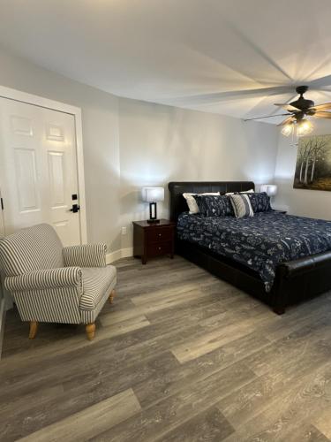 a bedroom with a bed and a couch and a chair at Rivers Edge 703c in Helen
