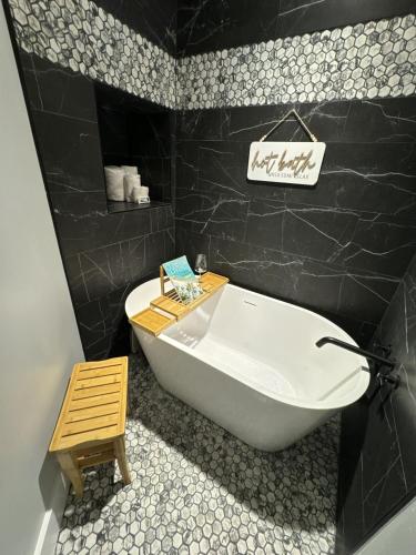a bathroom with a white tub and a wooden stool at Rivers Edge 703c in Helen