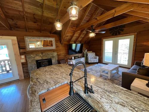 a living room with a fireplace in a log cabin at Bavarian Brook Condo 14 in Helen