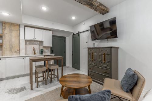 a kitchen with white cabinets and a table and chairs at Park Hotel Studio Suite 303 in Chattanooga