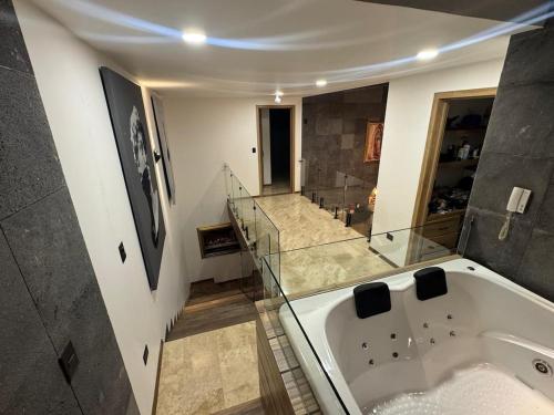 a large bathroom with a tub and a staircase at Residencia con alberca in Las Ánimas