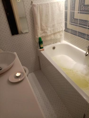a bathroom with a white tub and a sink at Affitta camere Explora caffè in Trieste