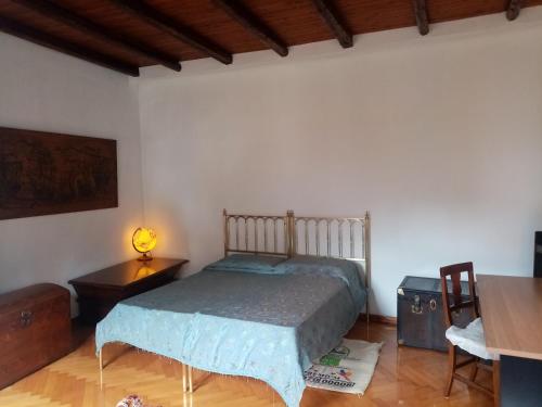 a bedroom with a bed and a table and a lamp at Affitta camere Explora caffè in Trieste