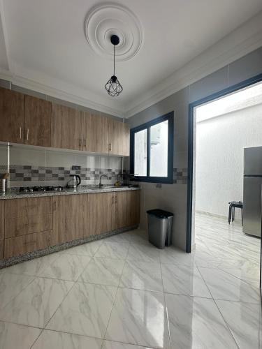a large kitchen with a sink and a counter at Al Hoceima Mini Villa in Al Hoceïma