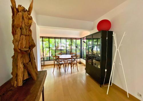 a living room with a table and chairs and a large window at G-63 - Appartement de standing en plein coeur d'Hossegor in Soorts-Hossegor