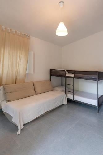 a bedroom with a bed and a desk in it at Villaggio Campeggio Nettuno di Paestum in Paestum