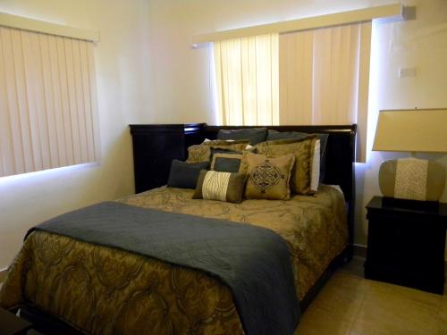 a bedroom with a large bed with pillows at Pedro Villas in Tamuning