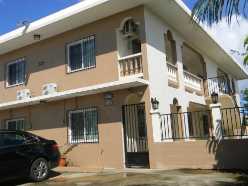 a building with a car parked in front of it at Pedro Villas in Tamuning