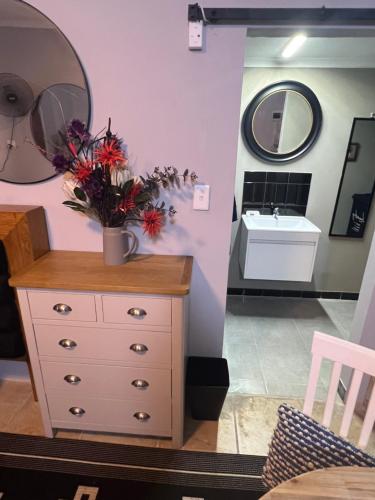 a bathroom with a white dresser and a sink at Little West in Margate