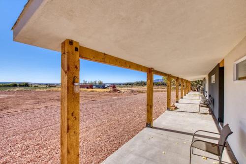 a porch of a building with a chair on it at Red Rock Views Tiny Suite Kanab Basecamp in Kanab