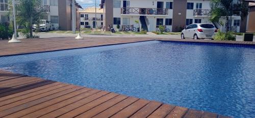 a white car parked next to a swimming pool at Brisas do Lago II in Paulo Afonso