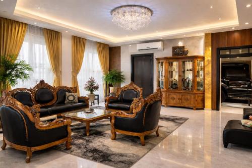 a living room with furniture and a chandelier at Kandy Royal Resort in Kandy