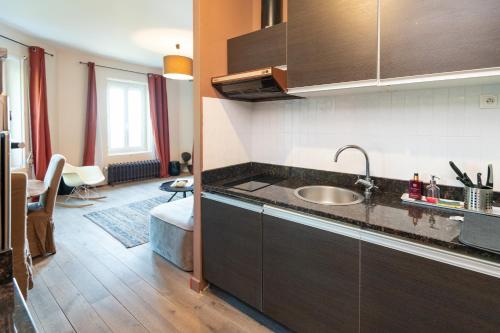a kitchen with a sink and a counter top at Maison Valmer - Le négociant, élégant F2 classé 4 étoiles in Le Havre