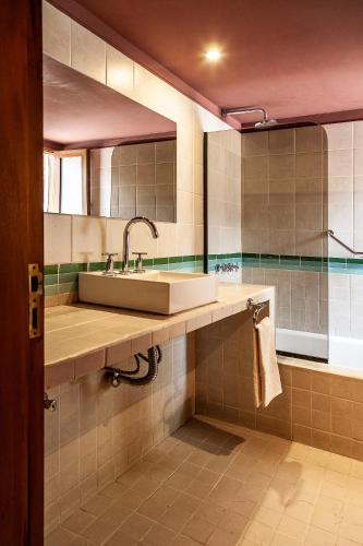 a bathroom with a sink and a large mirror at La Comarca Hotel in Purmamarca