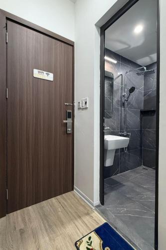 a bathroom with a toilet and a sink and a door at Phoenix home in Phù Ninh