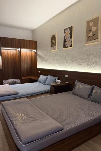 two beds in a hotel room with two beds at Phoenix home in Phù Ninh