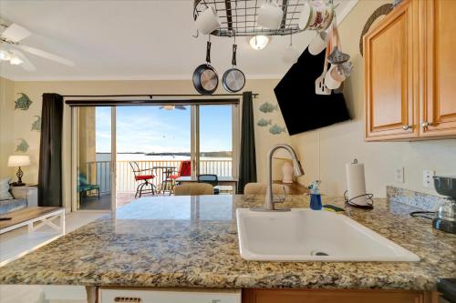 a kitchen with a sink and a view of the ocean at Sunsets Waterview Balcony King Bed & Heated Pool in St. Petersburg