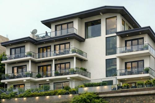 an apartment building with balconies and plants at Kandy Royal Resort in Kandy