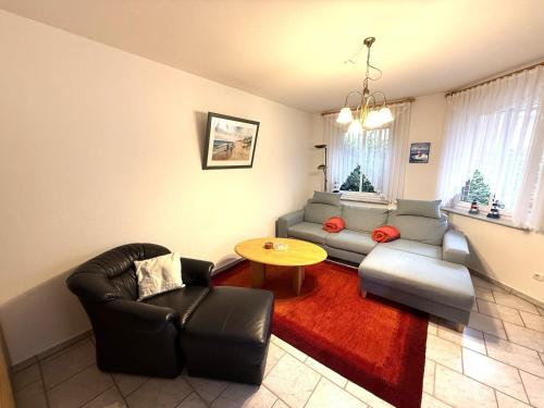 a living room with a couch and a table at Haus Meeresrauschen, Whg 1 in Duhnen