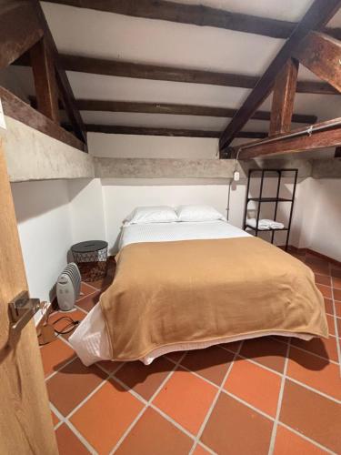 a bedroom with a large bed in an attic at Hostal Boutique Loto de Belén in Bogotá