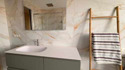 a bathroom with a sink and a mirror at NB Luxury Attico Vista Mare in Sanremo