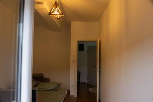 a hallway with a couch and a light on the ceiling at D&A Apartments in Novi Pazar